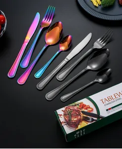 Detail of colorful and matte black stainless steel cutlery set with mirror finish