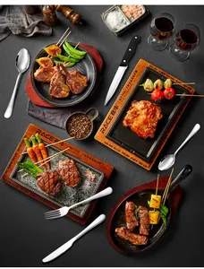 Polished stainless steel cutlery set shown with steak and wine on a rustic table