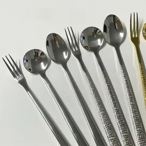 Detailed macro view of polished stainless steel spoon and fork with textured handles
