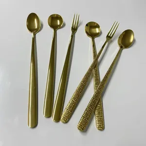 Macro detail of gold-plated 304 stainless steel spoons and forks with hammered textures