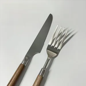 Detailed macro of 304 stainless steel steak knife and fork with walnut wood handle