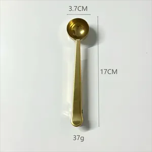 Detailed view of 17cm golden stainless steel coffee scoop with integrated sealing clip