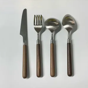 Macro detail of 304 stainless steel cutlery set with elegant walnut wood handles