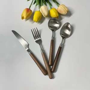Close-up of walnut handle cutlery set with stainless steel knife, fork and spoons