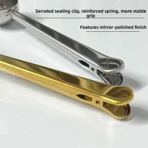 Detail of stainless steel coffee scoop with serrated sealing clip and mirror finish