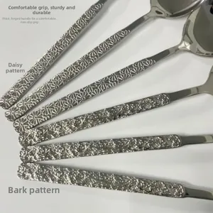 Detail of 304 stainless steel spoons with daisy and bark textured artistic handles