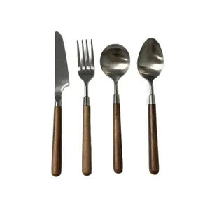 Modern 4-piece stainless steel cutlery set with walnut wood handles on white background