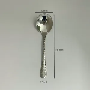 Detail of 304 stainless steel hammered spoon with mirror finish, 16.8cm long