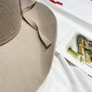 Detail of khaki wool felt fedora featuring a matching grosgrain ribbon trim and soft texture