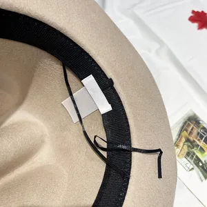 Detailed interior of a beige wool cowboy hat featuring the adjustable inner ribbon