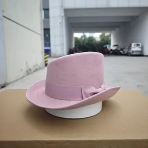 Detail of pink wool felt fedora featuring a stylish matching silk ribbon and bow
