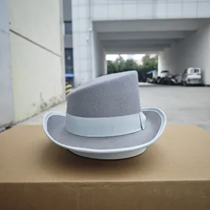 Detail of light gray wool felt fedora featuring a slanted crown and blue ribbon trim