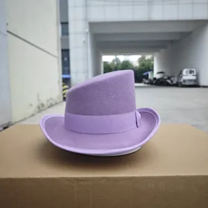 Detail of lavender wool fedora with ribbon trim showing unique asymmetric crown design