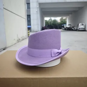Detailed close-up of a purple wool felt fedora with matching ribbon and bow decoration