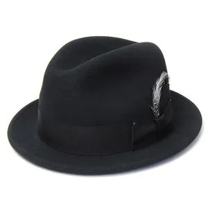 Detail of wool fedora hat featuring elegant black ribbon and feather decoration