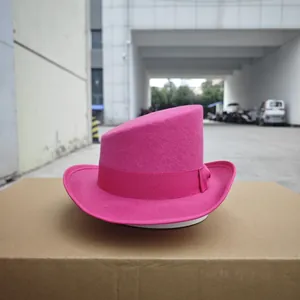 Detail of fuchsia wool felt top hat with asymmetrical crown and grosgrain ribbon trim