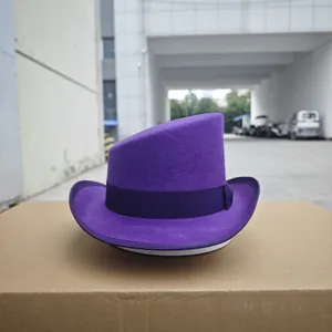 Detail view of purple wool fedora with asymmetrical crown and ribbon on a shipping box