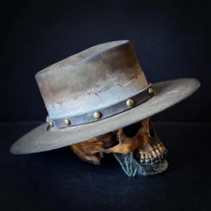 Detail of vintage wool fedora with distressed finish and leather studded band
