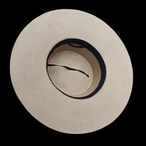 Detail view of the beige wool fedora hat interior showing the black sweatband and sizing tie