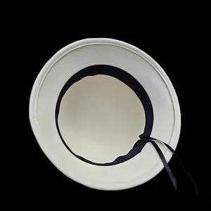 Macro shot of the adjustable black ribbon inside a white wool felt cloche hat