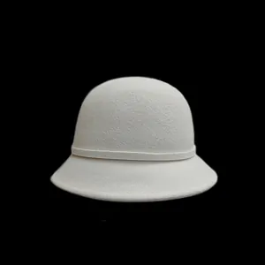 Detailed texture of elegant cream white wool felt bucket hat with matching decorative band