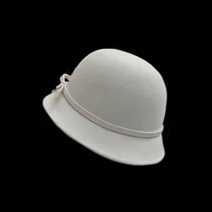 Elegant off-white wool felt cloche hat with ribbon bow detail on black background