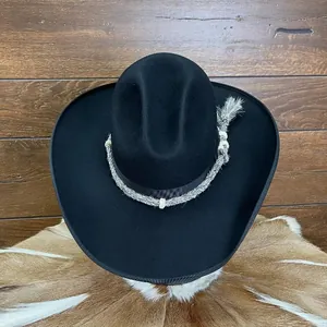 Classic black wide-brim wool felt cowboy hat with decorative woven band on wood background