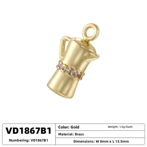 Detailed view of brass coffee pot pendant with gold plating and cubic zirconia accents
