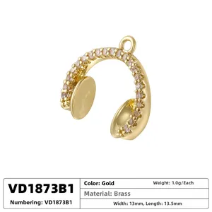 Detailed view of a gold-plated headphone pendant with cubic zirconia and brass material specs