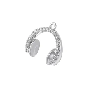 Macro detail of silver headphone pendant featuring sparkling pave-set zircon gemstones