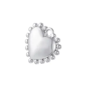 Detailed close-up of a silver heart-shaped pendant with a beaded border design