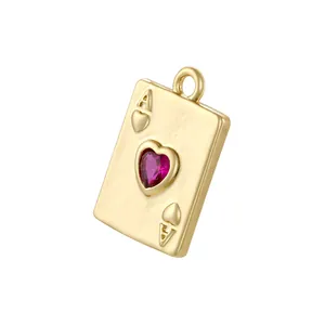 Close-up of gold Ace of Hearts pendant featuring a polished finish and red heart gemstone