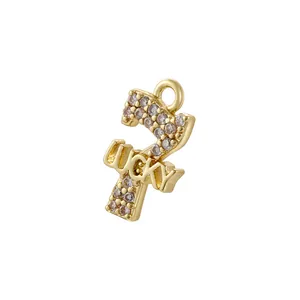 Detailed view of a gold number 7 pendant with pink zircons and lucky engraving
