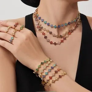 Detailed close-up of clover-shaped jewelry set with colorful stones on a golden base