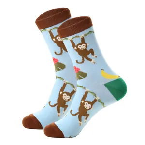 Detail of blue cotton socks featuring cartoon monkey patterns and reinforced heel
