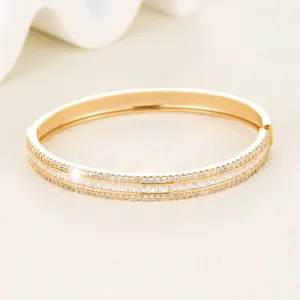 Detailed macro view of gold plated clasp bracelet with three rows of cubic zirconia