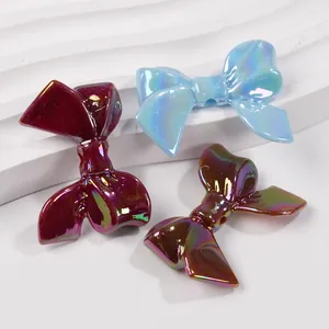 Three vibrant macaron-colored resin bow charms with AB coating for DIY jewelry making