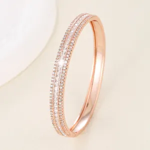 Detail of rose gold bracelet featuring three rows of zircon stones and side clasp