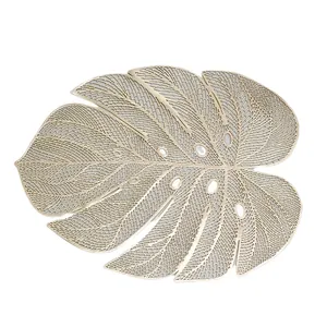 Champagne gold monstera leaf placemat with hollowed-out veins for heat resistance