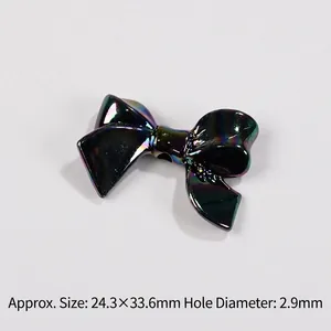 Detail of macaron bow bead with iridescent finish measuring 24.3x33.6mm and 2.9mm hole