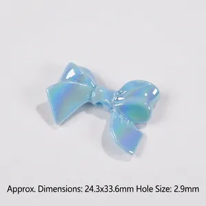 Detail view of light blue iridescent bow bead showing dimensions 24.3x33.6mm for DIY crafts