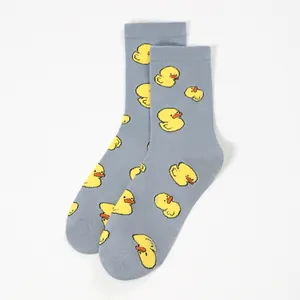 Mid-cut crew socks featuring gray cotton fabric and cute yellow duck patterns on a white background
