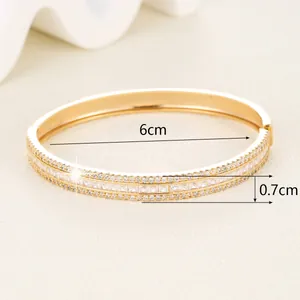 Detail of 0.7cm wide gold bangle with micro-paved cubic zirconia and 6cm inner diameter