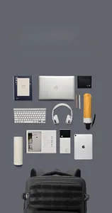Flat lay showing large capacity interior of black tactical backpack with laptop and gear