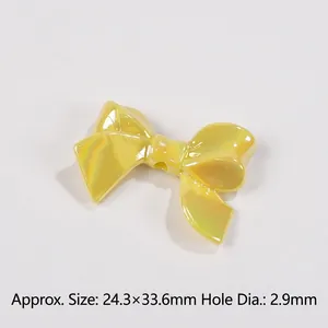 Macro detail of yellow macaron bow bead showing polarized coating and 2.9mm hole diameter