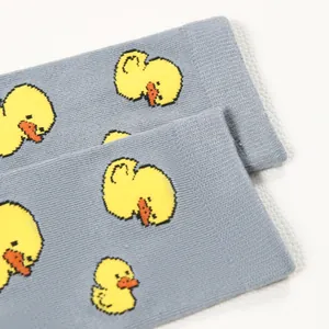 Grey knit cotton socks with cute yellow duck patterns in a high-quality close-up view