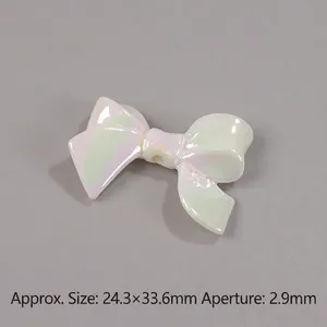 Detailed view of iridescent resin bow bead with measurements of 24.3x32.6mm for DIY jewelry