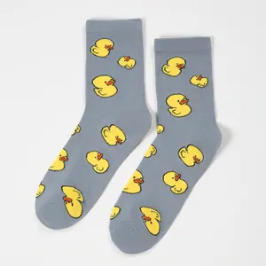 Gray crew socks with yellow duck pattern and ribbed cuffs on a white background