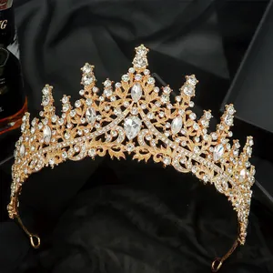 Elegant gold vintage bridal crown with crystal rhinestones on black satin background