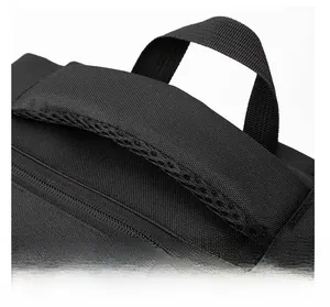 Detail of reinforced black nylon handle with breathable mesh padding on the travel backpack